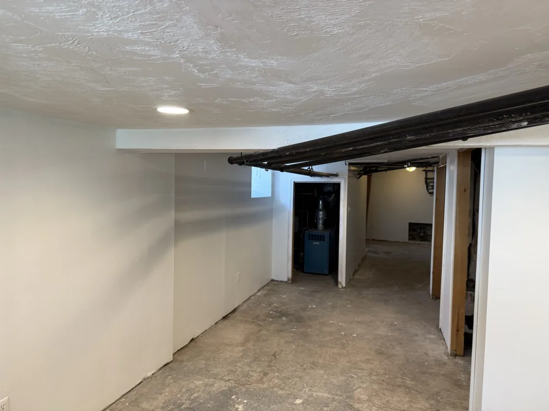 Finished Cambridge basement after drywall repair, primer, and paint